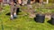 Woman sorting weed and flowers using shovel and hands in Eastern European village