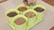 A woman sows microgreen seeds in pots