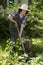 Woman with spade in a garden