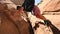 Woman Spans Two Rock Walls while climbing over crevasse