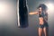 Woman sparring punching bag in gym