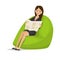 Woman specialist, rests, relaxes, with newspaper in hands on armchair.