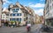 Woman speeding on a bicycle and tramline and ancient houses street view in Basel old town Switzerland