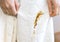 Woman spills coffee spot on white bathrobe. Dirty clothes