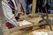 woman spinning cotton into thread with traditional wheel