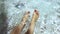 Woman splashing feet in the pool. Dolly shot of a young woman happily squirting her feet in the pool.