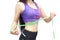 Woman in sport bra measuring her body with tape isolated on whit