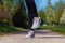 Woman in sport shoes on a sandy way