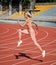 woman sport trainer in motion. speed and energy. stamina. sexy runner in fitness sportswear. sprinting on outdoor arena