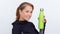 Woman in sportiv dress holding green thermos bottle with water