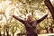 Woman in sports clothing enjoying in forest after exercis