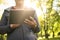 Woman in sports clothing using digital tablet in park.