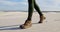 Woman in sports shoes walking in the desert 4k