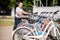 A woman in sportswear choosing a bike for rent