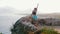 A woman in sportswear enjoys nature on a hill from the sea