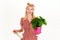 Woman with spray bottle spraying houseplants. Watering concept. Irrigation. Girl take care of flowers.
