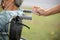 Woman is spraying alcohol,disinfectant spray on wheelchair handlebar hand,prevent infection,pandemic of Covid-19,spread of