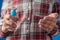 Woman spraying antiseptic on hands - close up front view - spray disinfection