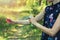 woman spraying mosquito and tick repellent on arm