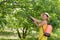 Woman spraying tree branches