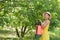 Woman spraying tree branches