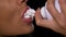 Woman spraying whipped cream into her sensual mouth