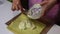 A woman is spreading cream on a sponge cake. Preparation of biscuit rolls. Stages of preparation.