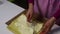 A woman is spreading cream on a sponge cake. Preparation of biscuit rolls. Stages of preparation.