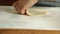Woman spreading dough with rolling pin