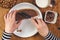 Woman spreading hazelnut nougat cream over bread slice