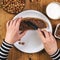 Woman spreading hazelnut nougat cream over bread slice