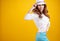 Woman with spring hat against yellow background