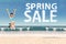 Woman with spring sale text shaped clouds