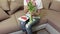 Woman with spring tulips sitting on couch