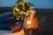 Woman with sprklers near car and Christmas tree outdoors