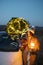 Woman with sprklers near car and Christmas tree outdoors