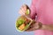 Woman squeezing lime on fish taco against background, closeup