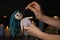 Woman stabbing voodoo doll with pin in dark room. Curse ceremony