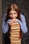 Woman with stack of books she wants to study.