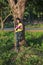 Woman stading at the tree and reading a book in the park