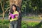 Woman stading at the tree and reading a book in the park