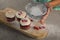 Woman staining flour on cupcakes