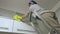 Woman on stairs cleaning furniture in kitchen