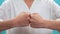 Woman stand and hand use fist bump on blue background