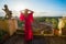 Woman standing on balcony overlooking Rome early in the morning
