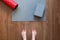 Woman is standing barefoot on floor in front of gymnastic mat and roller, she is going to do morning exercise complex. Only feet