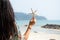 Woman standing on the beach in summer with starfish in hand