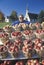 Woman standing behind apple baskets