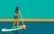 Woman standing on Board with a Paddle. Standup paddleboarding SUP. Sports Girl at sea, ocean. Stand up paddle surfing. Summer