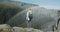 Woman standing at cliff edge looking down the canyon with river near Detifoss waterfall in Iceland